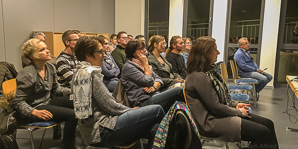 Ca 20 interessierte Eltern und Lehrer hÃ¶ren im Gemeinderaum gespannt dem Vortrag zu